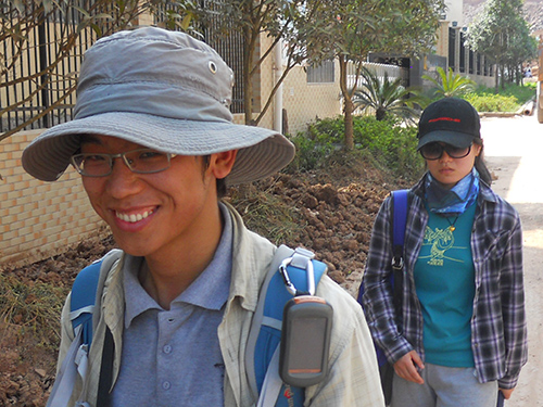 Wenjie and Li walk back to the van after a very hot day of field work, but they're still happy! (Photo by Ethan Schreuder).